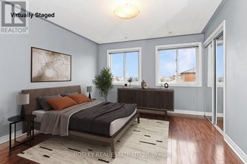 Toronto (Weston-Pellam Park) townhouse for rent - A bedroom with a large bed and a view of the city.