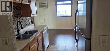 Windsor condo for rent - A kitchen with a sink and a refrigerator.