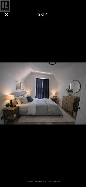 London East (East D) multi-family for rent - A bedroom with a bed, nightstand, and lamp.
