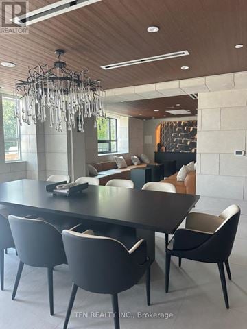 King (King City) condo for rent - A modern dining room with a large table and chairs.
