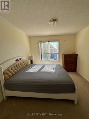 Markham (Wismer) apartment for rent - A bedroom with a bed, dresser, and window.