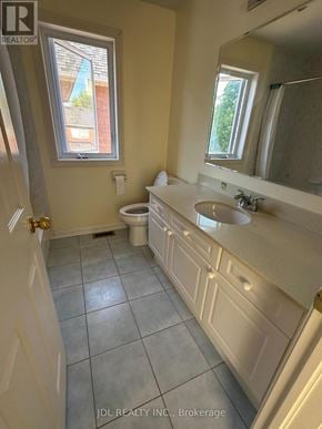 Markham (Wismer) apartment for rent - A bathroom with a toilet, sink, and mirror.