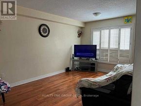 Toronto (West Humber-Clairville) apartment for rent - A living room with a flat screen TV and a clock on the wall.