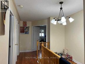 Toronto (West Humber-Clairville) apartment for rent - A living room with a staircase leading to the upper floor.