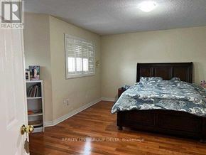 Toronto (West Humber-Clairville) apartment for rent - A bedroom with a bed, a window with blinds, and a bookcase.