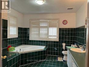 Toronto (West Humber-Clairville) apartment for rent - A bathroom with a black tiled floor and white walls.