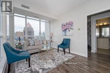 Mississauga (City Centre) condo for rent - A living room with a blue chair and a sofa.