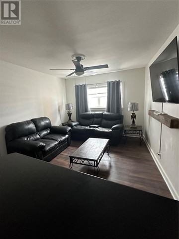 St. John's apartment for rent - A living room with black leather furniture and a flat screen TV mounted on the wall.
