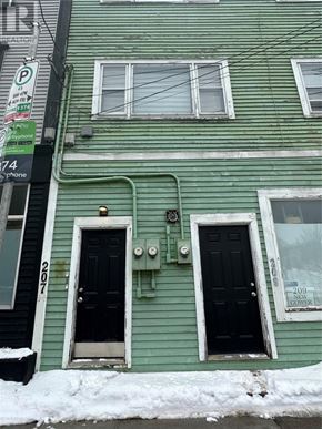 St. John's apartment for rent - A green house with a black door and a parking sign.