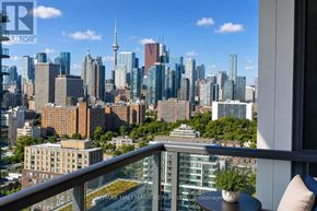 Toronto (Regent Park) condo for rent - A cityscape with a mix of modern and older buildings, with a clear blue sky above.