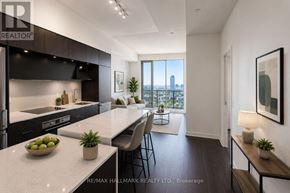 Toronto (Regent Park) condo for rent - A modern kitchen with a view of the city.