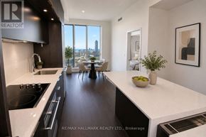 Toronto (Regent Park) condo for rent - A modern kitchen with a view of the city.