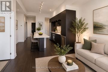 Toronto (Regent Park) condo for rent - A modern living room with a white sofa, a coffee table, and a large painting on the wall.