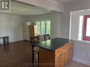 Oakville (Co Central) apartment for rent - A kitchen with a black countertop and wooden cabinets.
