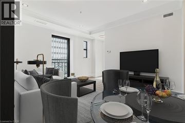 Hamilton condo for rent - A modern living room with a dining table set for two.