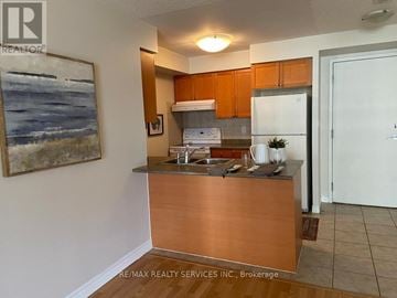 Mississauga (City Centre) condo for rent - A kitchen with a wooden counter and a painting on the wall.