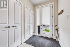 Burlington (Rose) townhouse for rent - A hallway with white doors and a brokerage sign on the wall.