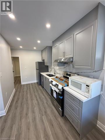 Hamilton apartment for rent - A kitchen with a white microwave oven on a counter.