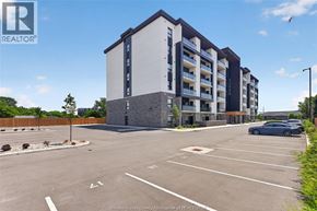 Windsor condo for rent - A parking lot in front of a building with a sign that says REALTOR.