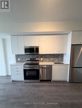 Brantford condo for rent - A kitchen with white cabinets and stainless steel appliances.