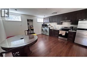 Vancouver apartment for rent - A kitchen with dark wood floors and modern appliances.