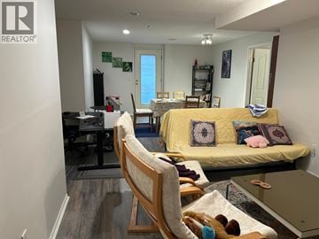 Coquitlam apartment for rent - A living room with a yellow couch and a wooden chair.