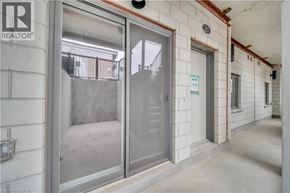 Cambridge townhouse for rent - A glass door with a sign on the wall behind it.