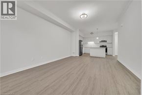 Cambridge townhouse for rent - A spacious room with wooden flooring and white walls.