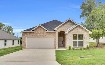 Ferris apartment for rent - A house with a garage door and a driveway.