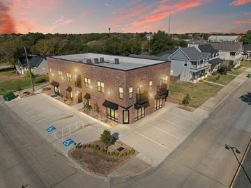 Ferris apartment for rent - A parking lot in front of a building with a parking space marked with a wheelchair symbol.