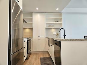 Langley apartment for rent - A modern kitchen with white cabinets and a stainless steel refrigerator.