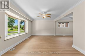 Toronto (Ionview) apartment for rent - A room with a ceiling fan and a window showing a view of a green lawn.
