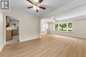 Toronto (Ionview) apartment for rent - A room with a ceiling fan and a window with a view of trees.