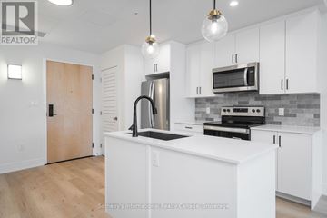 Clearview (Creemore) condo for rent - A modern kitchen with white cabinets and stainless steel appliances.