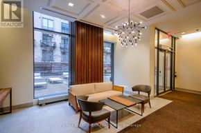 Toronto (Niagara) condo for rent - A living room with a couch, chairs, and a coffee table.