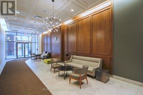 Toronto (Niagara) condo for rent - A waiting area with a brown carpet and wooden walls.