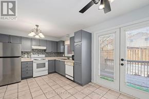 London East (East I) townhouse for rent - A kitchen with a refrigerator, oven, and sink.