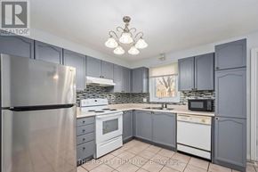 London East (East I) townhouse for rent - A kitchen with a refrigerator, microwave, oven, and sink.