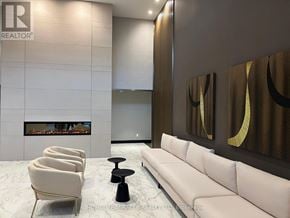 Milton (Walker) condo for rent - A modern living room with a fireplace and a white sofa.
