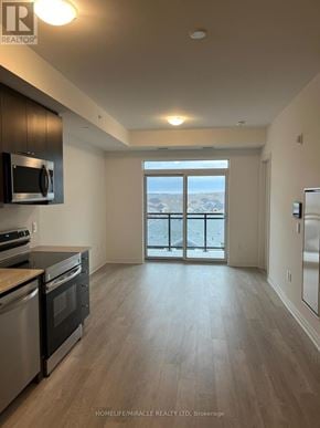 Milton (Walker) condo for rent - A spacious kitchen with stainless steel appliances and wooden flooring.