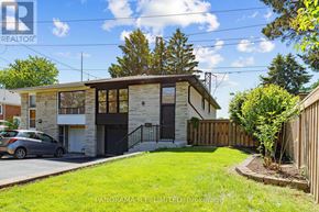 Mississauga (Cooksville) apartment for rent - A house with a car parked in front of it.
