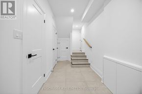 Mississauga (Cooksville) apartment for rent - A hallway with a staircase leading to a door at the end.