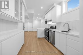 Mississauga (Cooksville) apartment for rent - A modern kitchen with white cabinets and appliances.