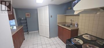 Toronto (West Hill) apartment for rent - A kitchen with a sink, stove, and cabinets.