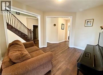 Waterloo apartment for rent - A living room with a brown couch and a piano.