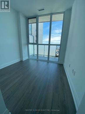 Toronto (Church-Yonge Corridor) condo for rent - A room with a view of the city through a large window.
