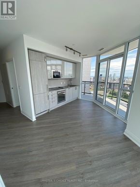 Toronto (Church-Yonge Corridor) condo for rent - A spacious kitchen with wood flooring and a view of the city.