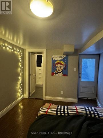 Toronto (Palmerston-Little Italy) townhouse for rent - A bedroom with a bed and a painting on the wall.