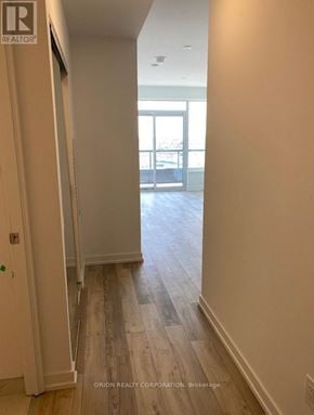 Pickering (Bay Ridges) condo for rent - A hallway with wood floors and white walls.