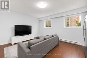 Toronto (O'connor-Parkview) townhouse for rent - A living room with a grey couch and a flat screen TV.